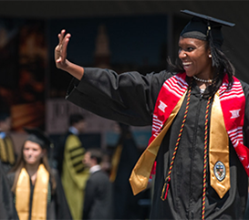 Student Waving at Graduation
